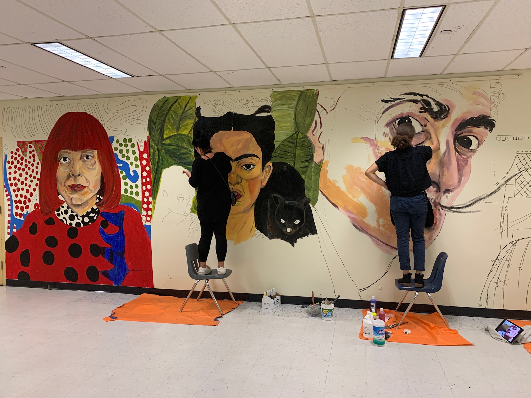 Western High School art students painting the Wall of Artists mural